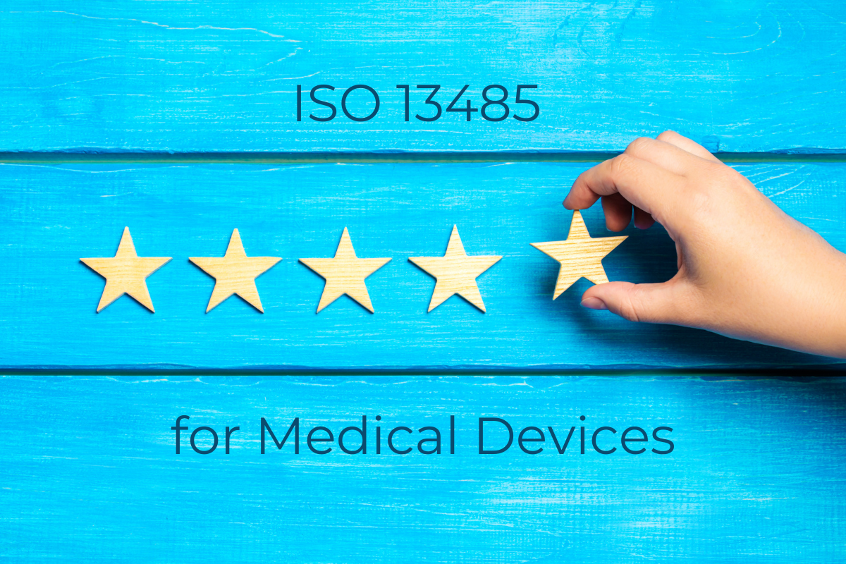 ISO 13485 for Medical Devices - hand placing 5 stars on a blue wood background
