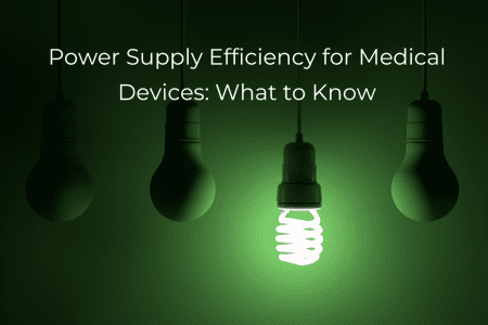 Power Supply Efficiency for Medical Devices: What to Know - Image of four lightbulbs on a green backgournd, one is illuminated and is CFL