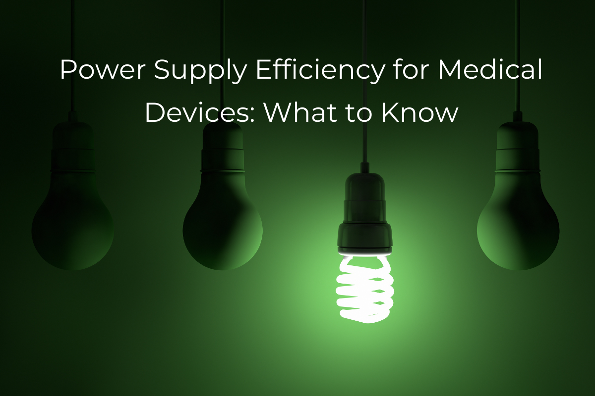 Power Supply Efficiency for Medical Devices: What to Know - Image of four lightbulbs on a green backgournd, one is illuminated and is CFL